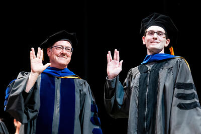  Prof. Kris Pister and Daniel Teal share a Vulcan salute. UC Berkeley COE Ph.D. Commencement 2024.